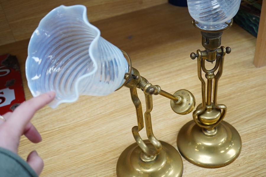 A pair of brass Pullman lamps with gimbal stems and Vaseline glass shades, modelled for wall mounting or freestanding, height to top of shade 40cm. Condition - good